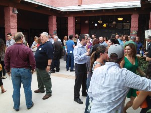 People gathered in the courtyard of the YWCA Tucson for networking and conversation before the Demo Day presentations.